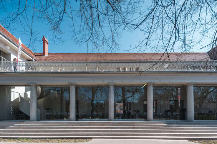 View of the historic Betonhaus in Poznań with columns and large entrance steps